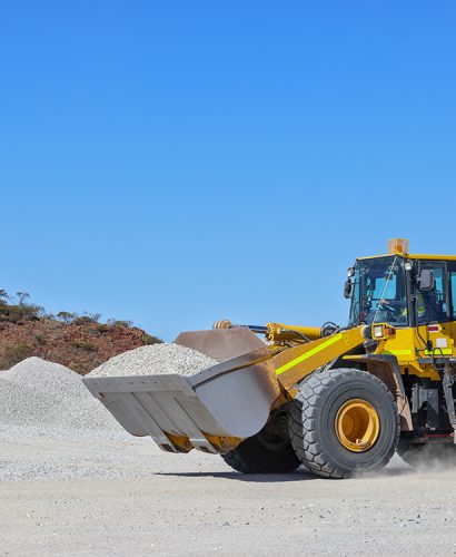 Front-end loader (bucket, payloader, high lift, shovel dozer, skid-steer, skip) moving ore, mine, Outback Western Australia
